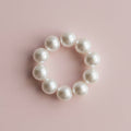 Pearl bracelet on a light wooden surface